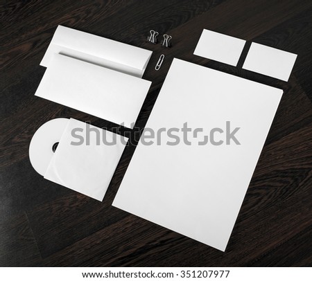 Photo of blank stationery and corporate id template on dark wooden background. Mock-up for branding identity for designers. Top view.