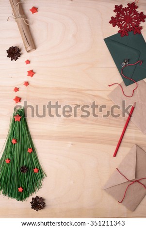 Xmas background with handmade fir tree, red stars and envelope. Top view, copy space.