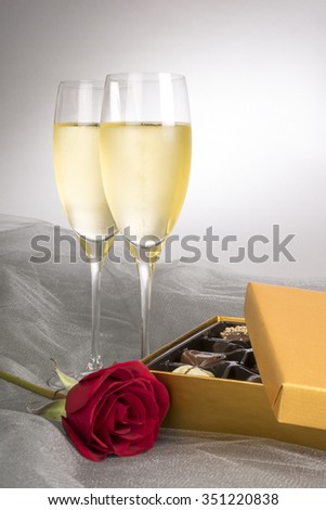 Two Glasses of Champagne, Single Red Rose and Box of Chocolates
