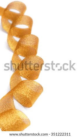 Gold ribbon of twisted spiral on a white background.
