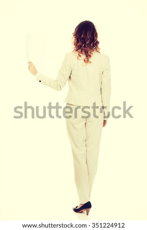 Businesswoman holding a blank paper sheet.