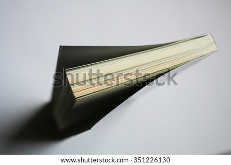 book ajar in the shape of an arrow