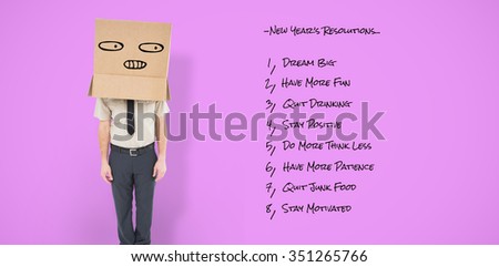 Businessman standing with box on head against pink