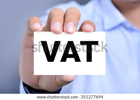 VAT letters (or Value Added Tax) on business card shown by a man