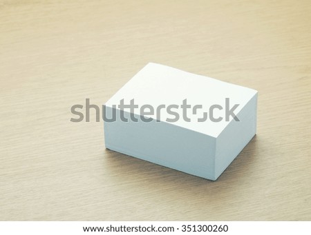 Blank white paper with space on wooden table.stack of papers - vintage filter.