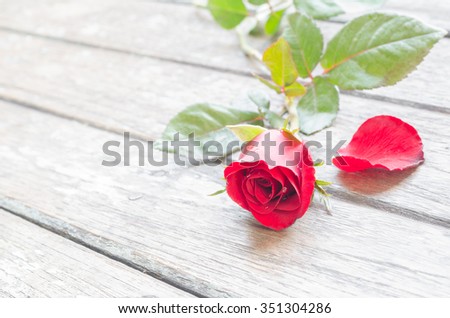 Vintage background with lovely rose flowers on wooden table