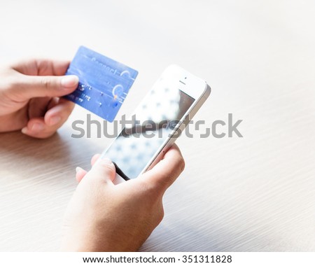 Close-up of man hands with smartphone and credit card as online shopping or online payment concept. Selective and shallow focus.