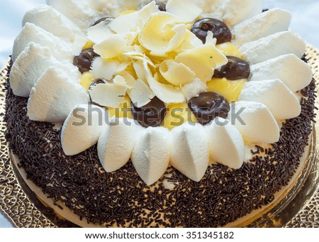 In the picture a chocolate cake with cream view from above