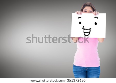 Full length portrait of beautiful woman holding blank billboard against grey vignette
