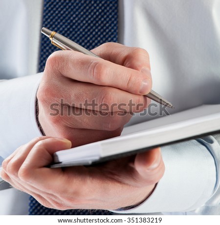 Businessman signing a contract, closeup shot