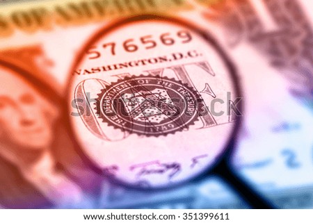 US one dollar bill under magnification glass