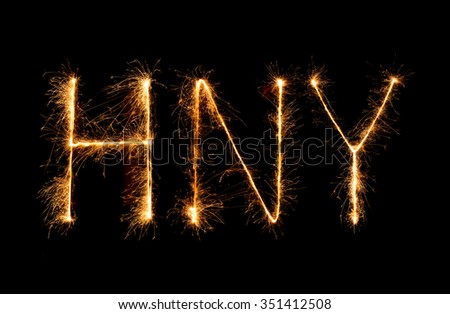 Happy New Year made of sparkles firework at night background