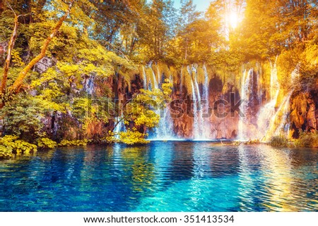 Majestic view on turquoise water and sunny beams.  Location famous resort Plitvice Lakes National Park, Croatia, Europe. Dramatic and vivid scene. Beauty world. Retro filter. Instagram toning effect. 