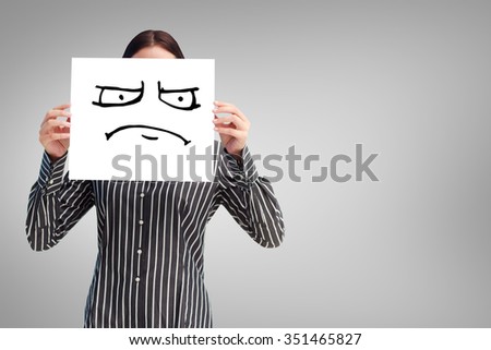 Businesswoman showing a white card in front of her face against white background with vignette