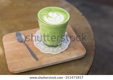 green tea latte on wood background. Greenery pantone