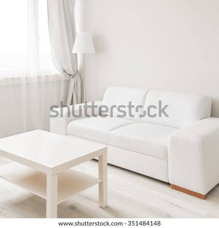 Picture of small table and sofa in simply furnished lounge