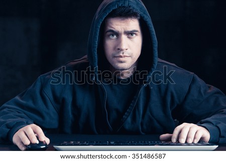 Photo of young cyber warior in black hoody