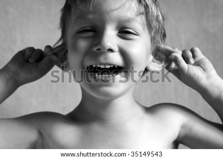 boy pulls himself over the ears