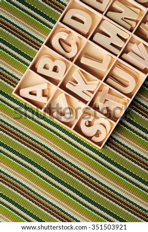 Close up wooden letter in box on color table cloth