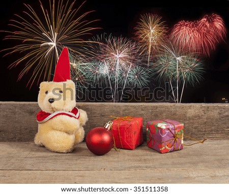 christmas decoration with toys teddy bear on firework background . 