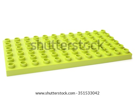 Green plastic construction baseplate on white background