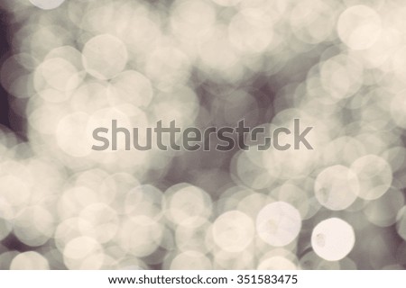 Picture of light blurred background with white bokeh lights on it. Festive holiday theme with copyspace
