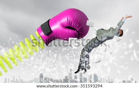 Young determined businessman fighting boxing glove on spring