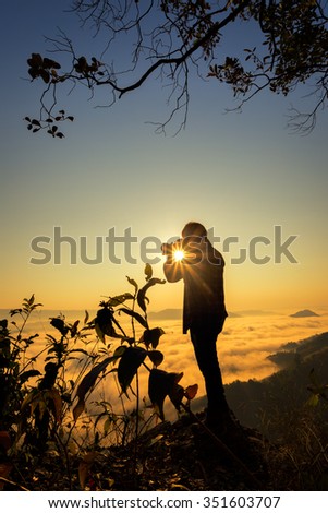 Photographers taking pictures of the mist at sunrise in Thailand