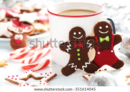 Christmas cookies with cup of hot coffee on a blue wooden table