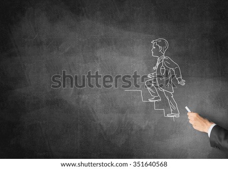 Male hand drawing with chalk doctor on blackboard