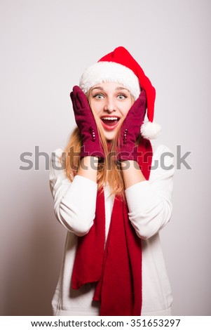 Christmas girl happy pleasantly surprised. Santa hat isolated portrait of a woman.