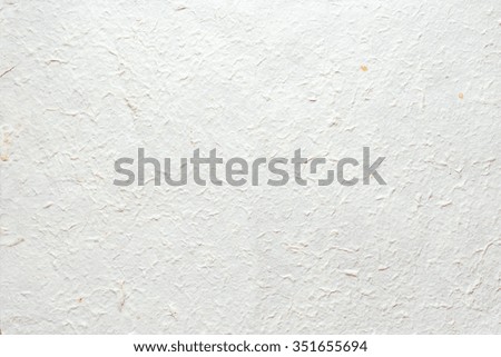 Abstract texture background. Handmade wrinkled paper with pieces of leaves. 