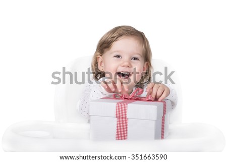 Beautiful little girl opening gift box with surprise on seasonal holiday occasions, Merry Christmas and Happy new year