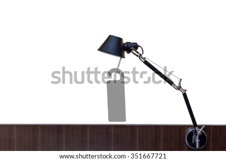 Table lamp with a tag and lower wood frame on pure white background.