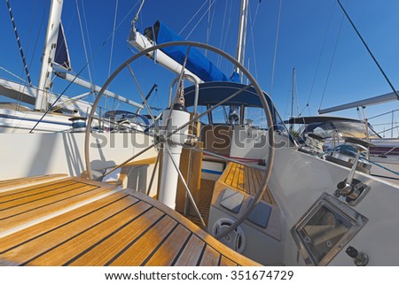 sailboat with lowered sail on a sunny day, wheel, mast, yachting, boat trip