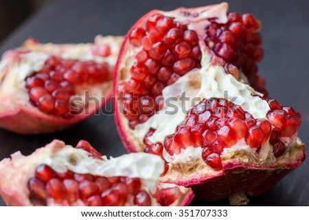 Pomegranate over wooden background