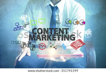businessman holding a tablet computer with CONTENT MARKETING text ,business concept 