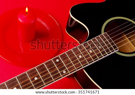 Guitar and burning candle