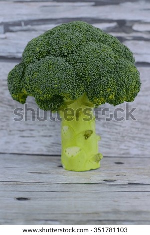 Raw broccoli on white wood background