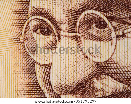 Mahatma Gandhi face on indian 500 rupee banknote extreme macro, India money closeup Royalty-Free Stock Photo #351795299