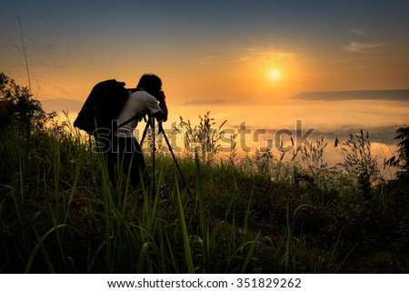 Photographers taking pictures of the mist at sunrise in Thailand

