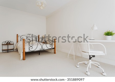 Horizontal picture of a spacious and bright female bedroom