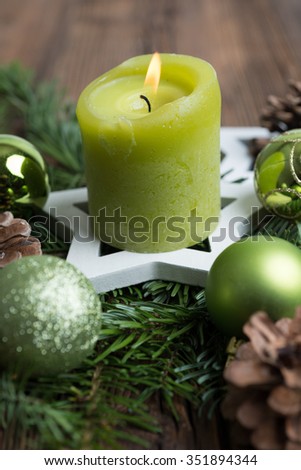 Christmas table decoration for Advent with burning candle
â??selected focus, narrow depth of fieldâ??
