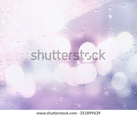 Drops Of Rain On Glass Background. Street Bokeh Lights Out Of Focus.
