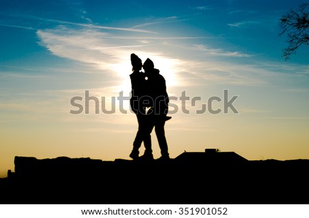 abstract blue clouds and sunset background silhouette of men and women, horizontal photo