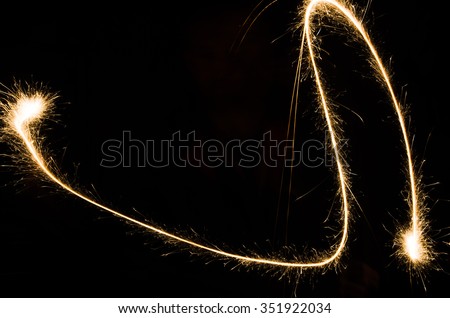 sparkler light trail in dark environment using slow shutter speed