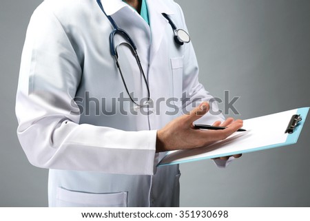 Close up view on doctor holding prescription board in hands