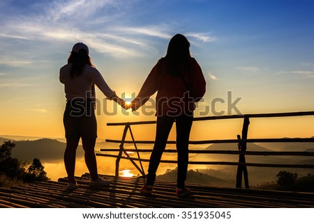 Two womans looking mist at sunrise in Thailand