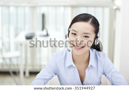 Female office worker wearing headset,portrait