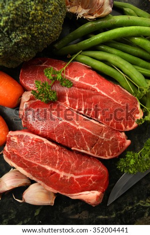Fresh raw beef lamb fillet with other ingredients over marble stone chopping board Royalty-Free Stock Photo #352004441